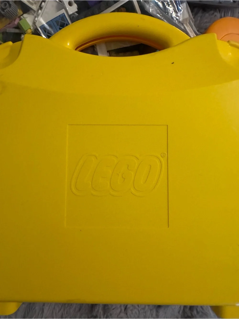 Lego Yellow and Orange Carry Cases filled with Lego bricks and a bag of boards